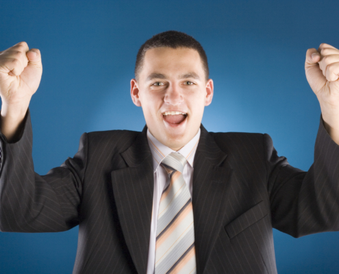 successful businessman with both hands up