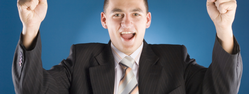 successful businessman with both hands up