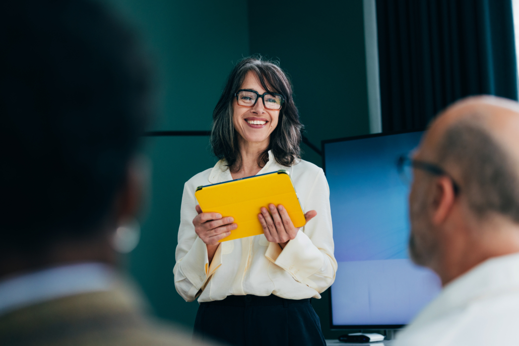 Confident Professional Woman Giving A Presentation In A Business Meeting Setting